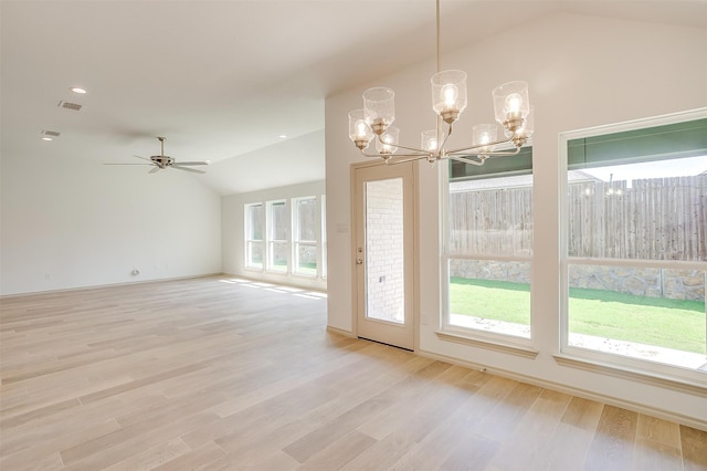 interior space featuring plenty of natural light, vaulted ceiling, and light hardwood / wood-style flooring