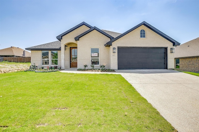 view of front facade with a garage and a front lawn