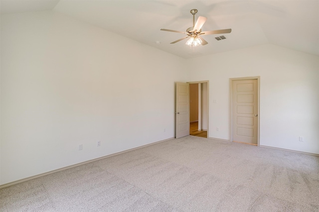 carpeted spare room featuring ceiling fan and lofted ceiling