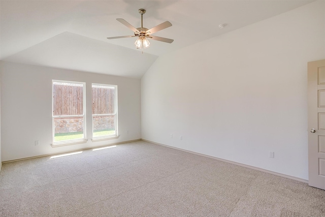 empty room featuring ceiling fan, carpet, and lofted ceiling