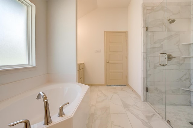 bathroom featuring vanity, independent shower and bath, and vaulted ceiling