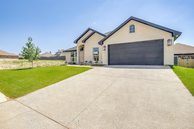 ranch-style house with a garage and a front lawn