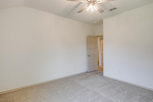 carpeted empty room featuring ceiling fan and lofted ceiling