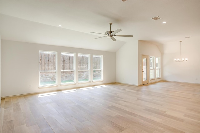 unfurnished living room with light wood-type flooring, vaulted ceiling, and plenty of natural light