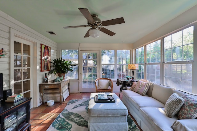 sunroom / solarium featuring ceiling fan