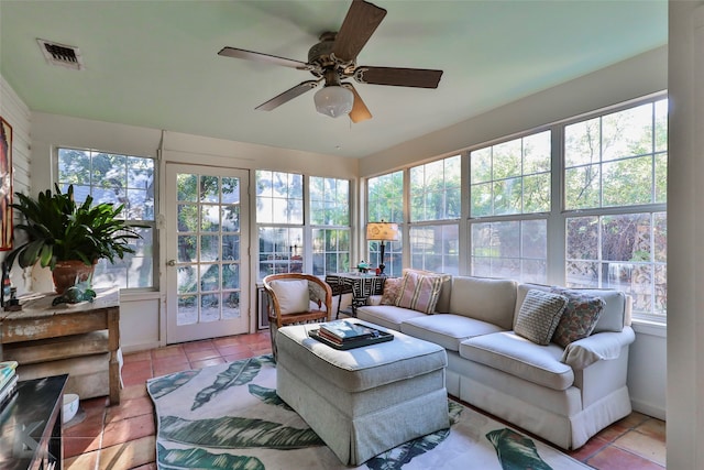 sunroom / solarium featuring a wealth of natural light and ceiling fan