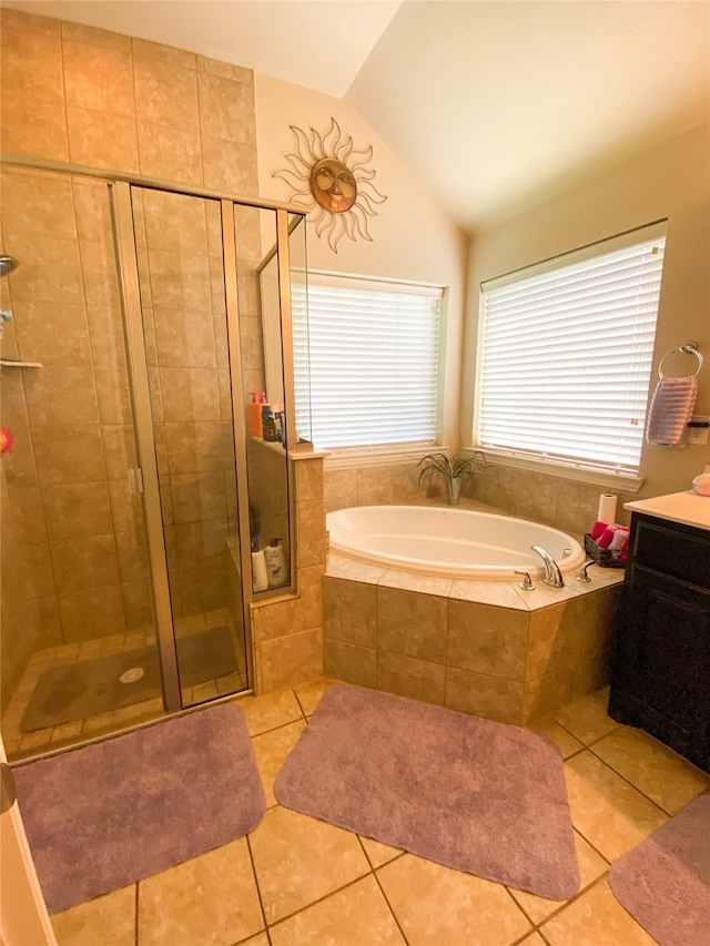 bathroom with tile patterned floors, vanity, shower with separate bathtub, and vaulted ceiling