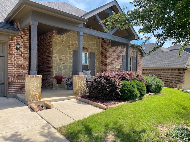 doorway to property featuring a porch and a yard