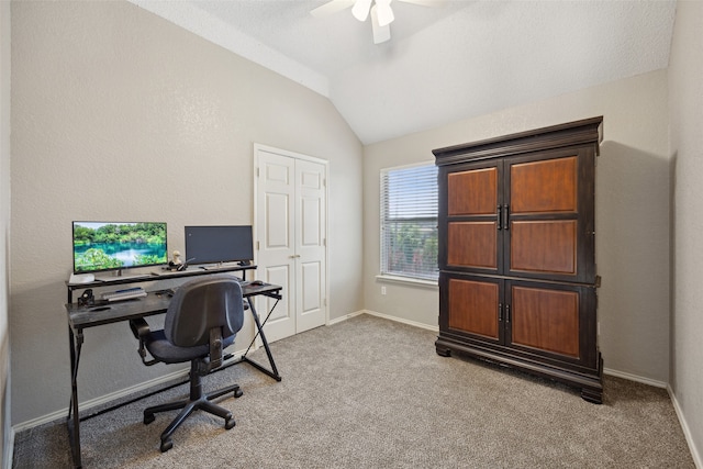 carpeted office space featuring ceiling fan and vaulted ceiling