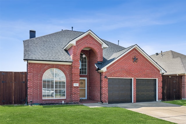 front of property with a front yard and a garage