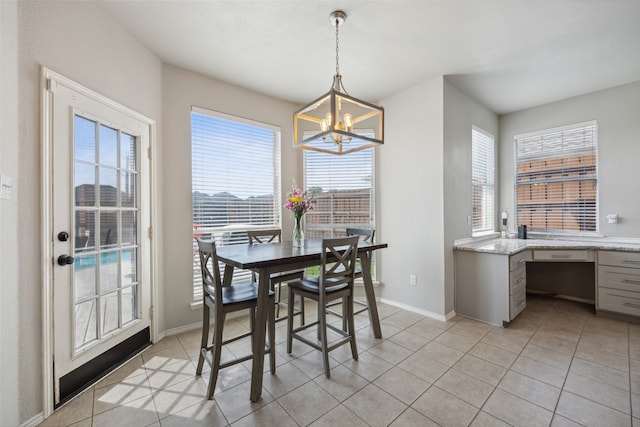 dining room featuring light tile patterned floors and a notable chandelier