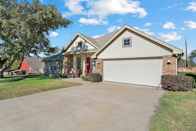 view of front of property featuring a front yard and a garage