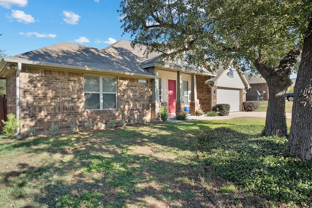 view of front of home with a front yard and a garage