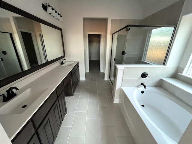 bathroom featuring a healthy amount of sunlight, shower with separate bathtub, tile patterned flooring, and vanity