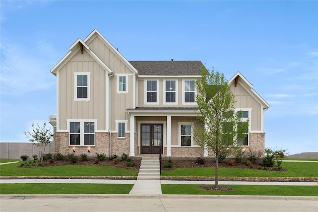 3208 Andesite Rd, Mckinney, TX 75071 - craftsman-style home with french doors, a front yard, board and batten siding, roof with shingles, and brick siding