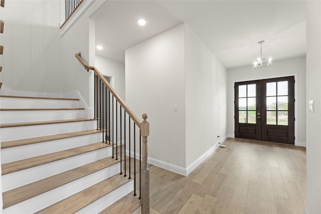 3208 Andesite Rd, Mckinney, TX 75071 - entrance foyer with wood finished floors, stairs, a chandelier, french doors, and baseboards