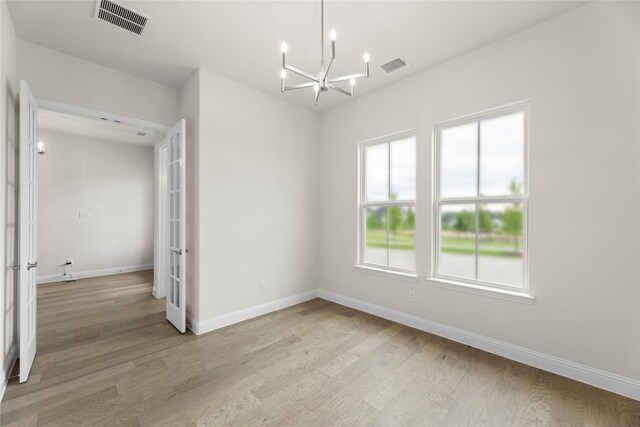 3208 Andesite Rd, Mckinney, TX 75071 - unfurnished bedroom with a chandelier, light wood-type flooring, and baseboards
