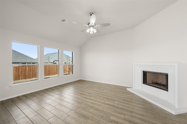 unfurnished living room featuring lofted ceiling and ceiling fan