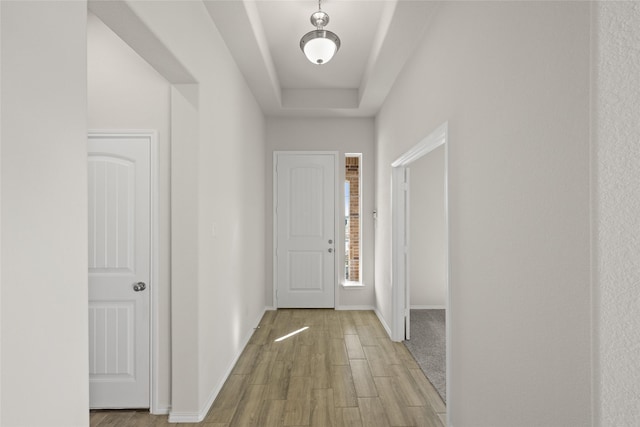 doorway featuring a raised ceiling