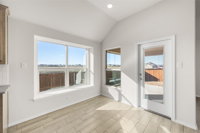 unfurnished room featuring vaulted ceiling