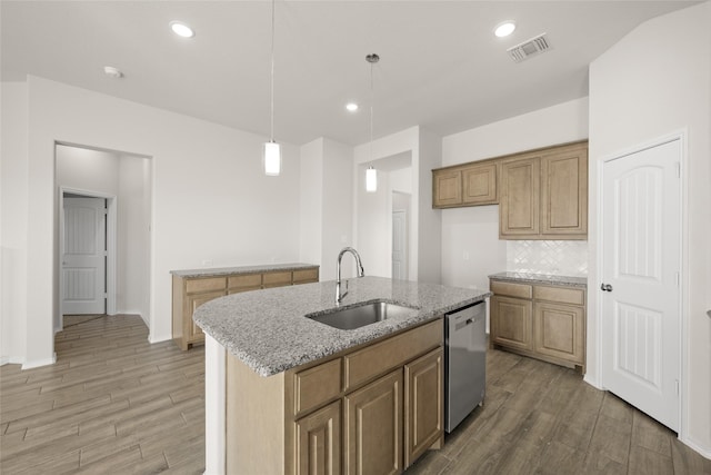 kitchen with decorative light fixtures, sink, a kitchen island with sink, stainless steel dishwasher, and light stone counters