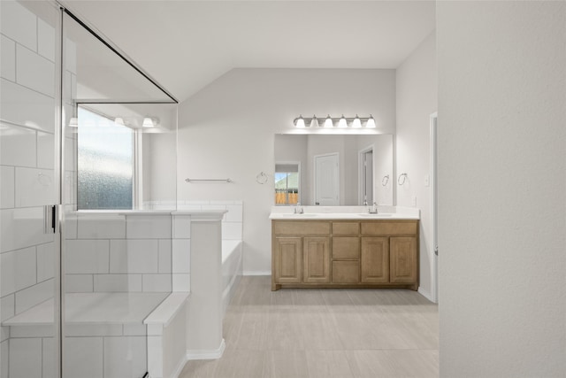 bathroom featuring vaulted ceiling, separate shower and tub, and vanity