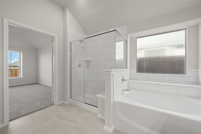 bathroom with vaulted ceiling, tile patterned floors, and independent shower and bath