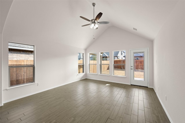 interior space with ceiling fan, dark hardwood / wood-style flooring, and high vaulted ceiling