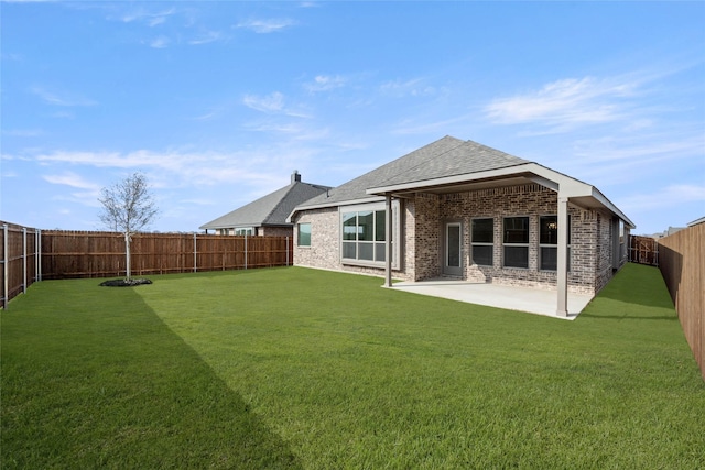 rear view of property featuring a yard and a patio area