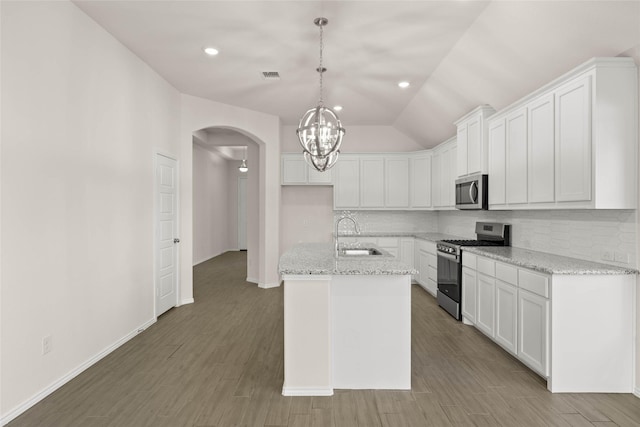 kitchen with a kitchen island with sink, sink, stainless steel appliances, and white cabinets