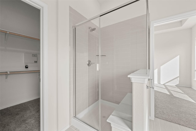 bathroom with a shower with door