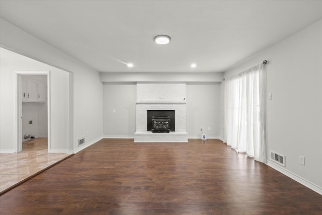 unfurnished living room with dark hardwood / wood-style flooring