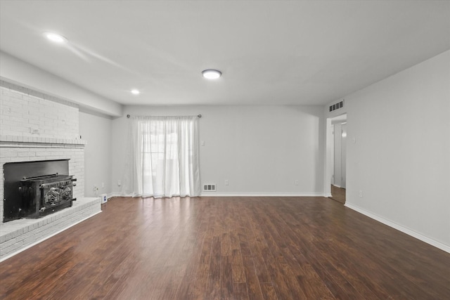 unfurnished living room featuring dark hardwood / wood-style floors