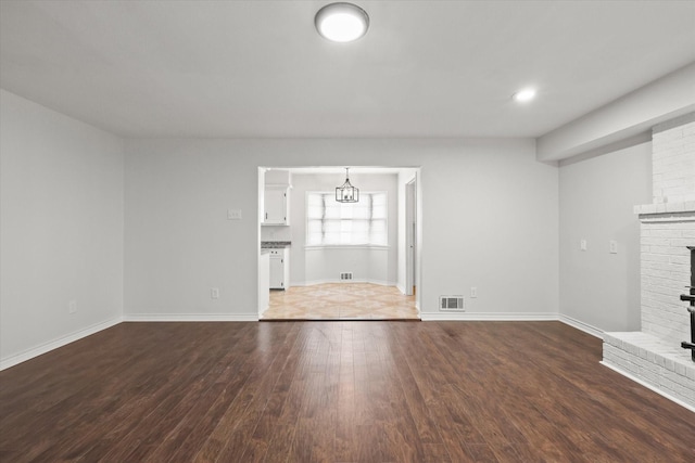 unfurnished living room with a fireplace and hardwood / wood-style floors