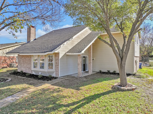 rear view of property featuring a yard