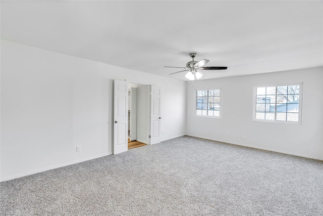 empty room featuring ceiling fan and carpet floors