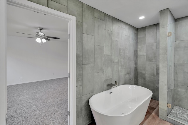 bathroom featuring ceiling fan, wood-type flooring, and independent shower and bath