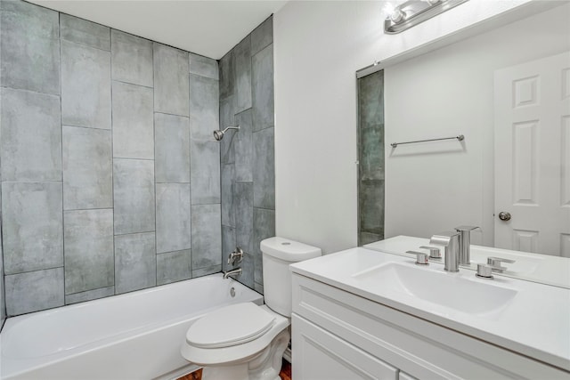 full bathroom featuring tiled shower / bath combo, toilet, and vanity