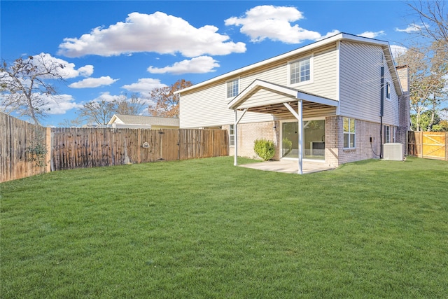 back of property featuring central air condition unit, a patio area, and a lawn