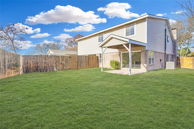 back of property featuring central air condition unit, a patio area, and a lawn