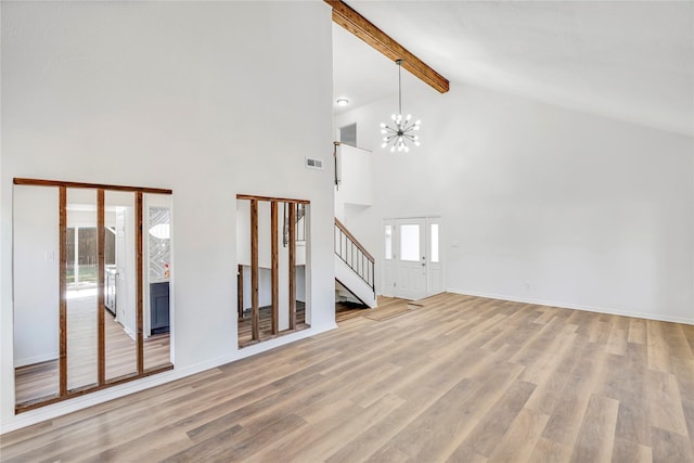 unfurnished living room featuring beam ceiling, high vaulted ceiling, light wood-type flooring, and a notable chandelier