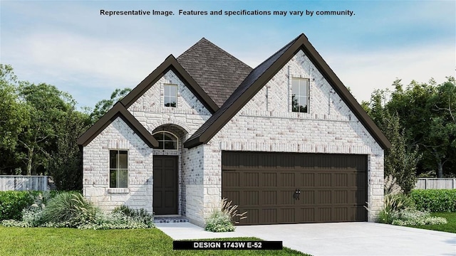 view of front of home with a garage and a front lawn