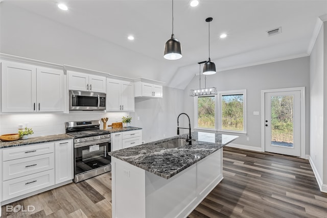 kitchen with white cabinetry, sink, decorative light fixtures, a center island with sink, and appliances with stainless steel finishes