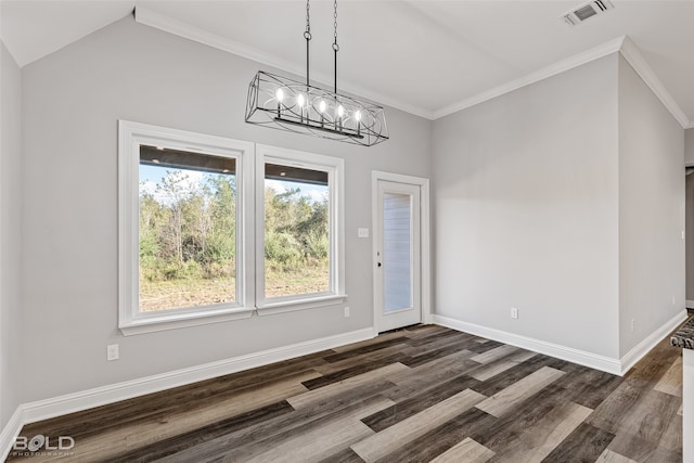 unfurnished dining area with lofted ceiling, ornamental molding, dark wood-type flooring, and an inviting chandelier