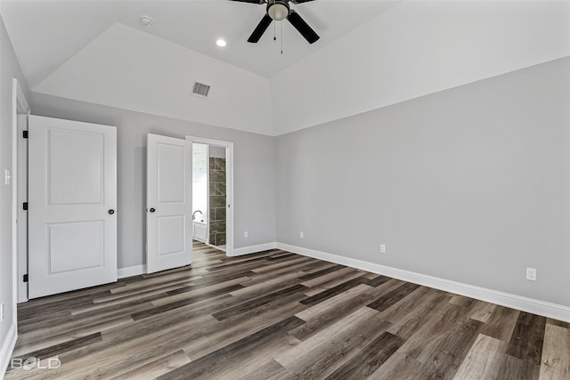 unfurnished bedroom featuring ceiling fan, dark wood-type flooring, and ensuite bath