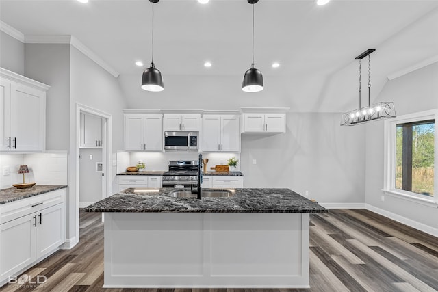 kitchen with a center island with sink, white cabinets, dark wood-type flooring, and appliances with stainless steel finishes