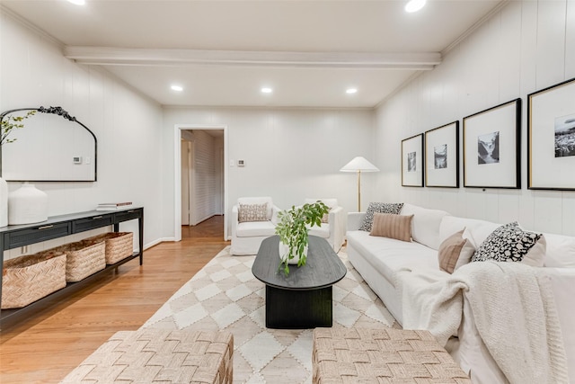 living room with beam ceiling, light hardwood / wood-style flooring, and ornamental molding