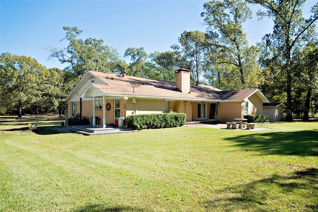 rear view of house featuring a lawn