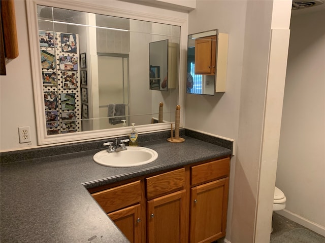 bathroom featuring vanity, toilet, and a shower