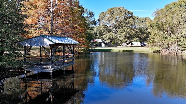 view of dock featuring a gazebo and a water view